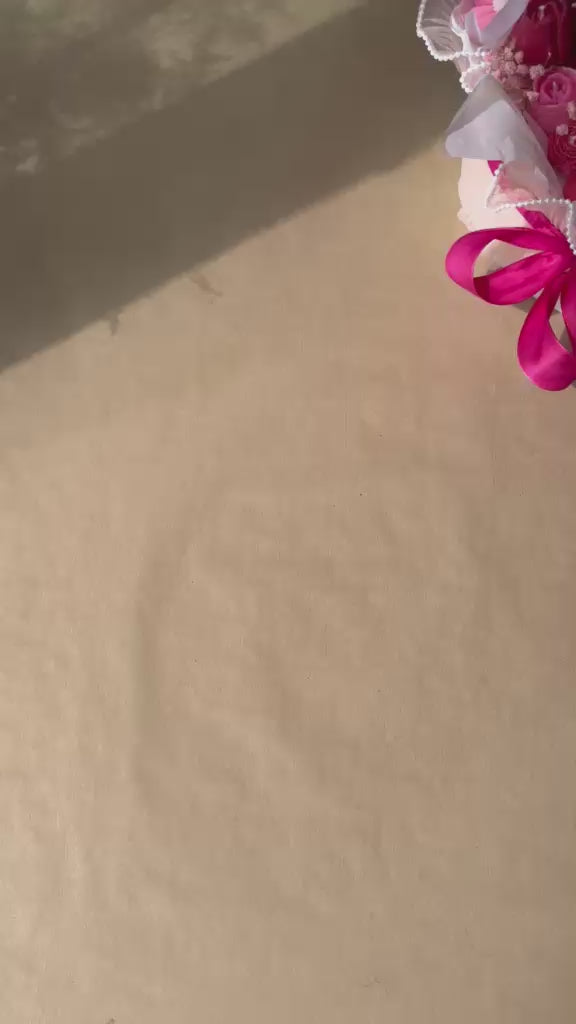 Bouquet of pink and red flowers with a pink ribbon 